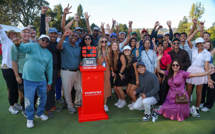 Sahith Theegala of the United States celebrates with friends and family alongside the trophy after winning during the final round of the Fortinet Championship at Silverado Resort and Spa on September 17, 2023 in Napa, California.